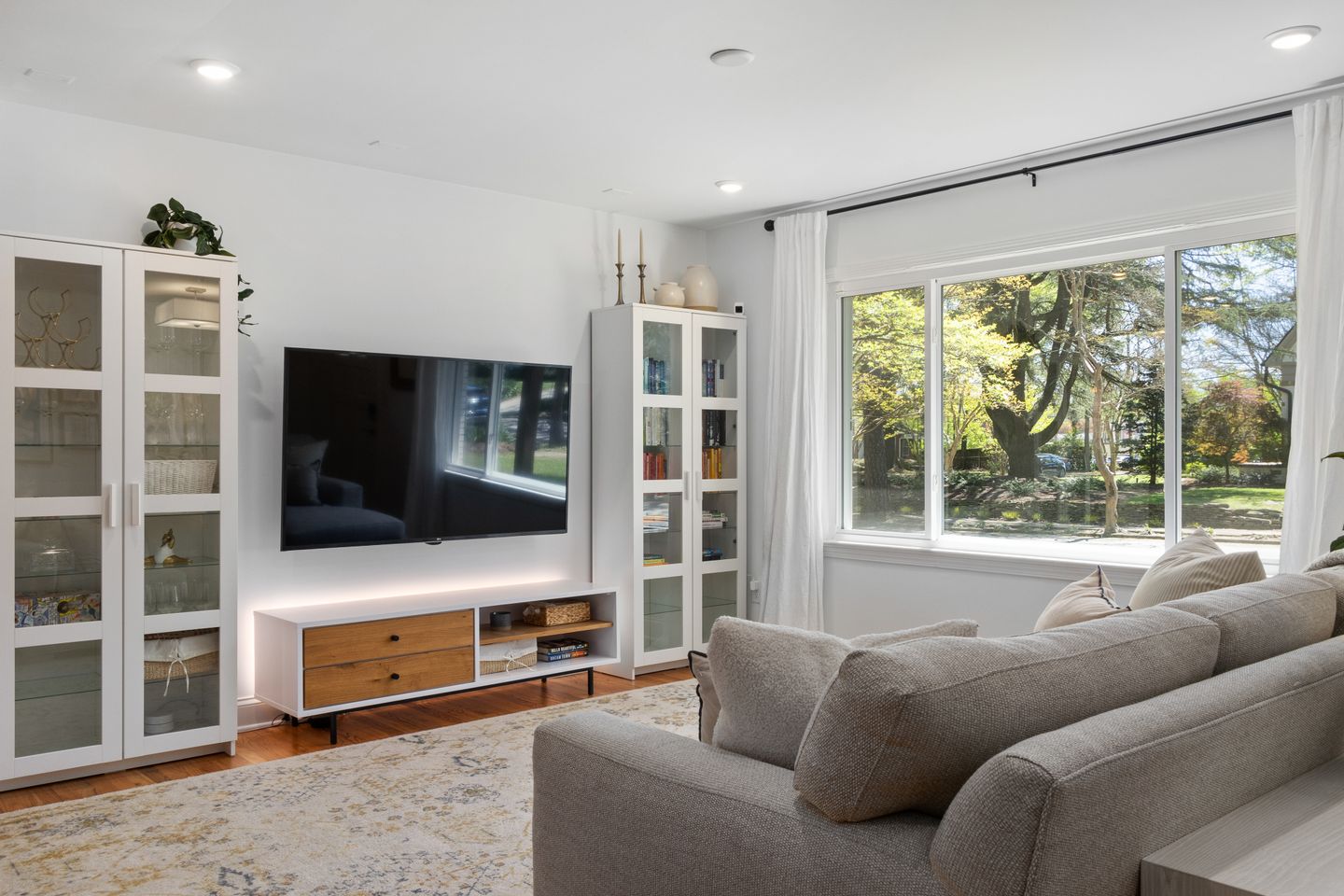 A bright living room arranged around a sofa and television