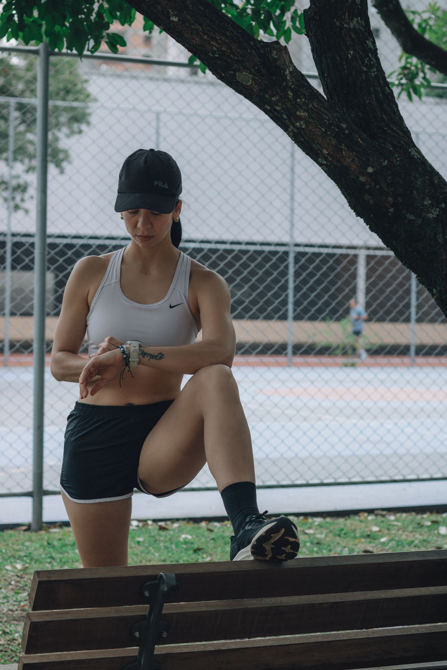 An athlete checking a smartwatch during an outdoor exercise session