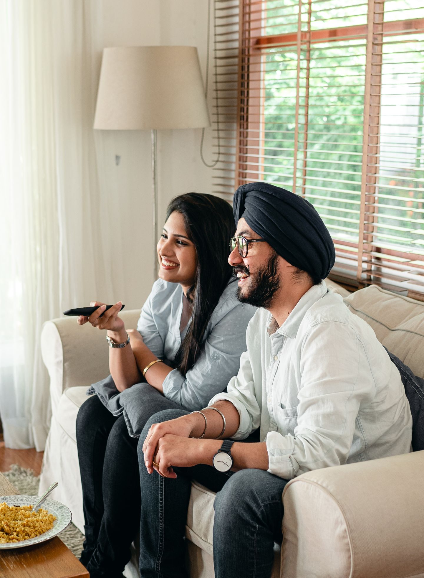A couple sharing a relaxed evening on a living-room sofa